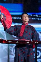 A person holding a red fan AI-generated content may be incorrect.